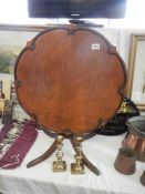 A mahogany tip top round table