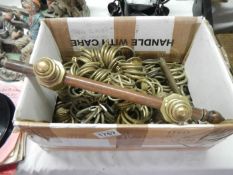 A box of brass curtain rings etc
