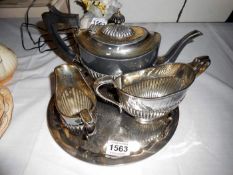 A silver plate tea set including teapot, sugar, milk, tray