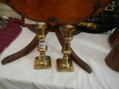 A pair of Victorian brass candlesticks