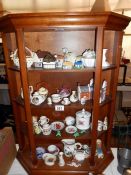 A display cabinet and 4 shelves of miniatures and curios