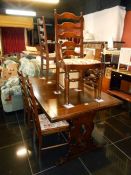 A good quality oak dining table with 6 ladder back chairs