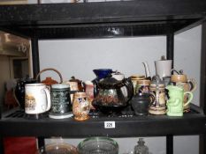 A shelf of steins, jugs, pots etc
