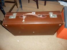 A brown vintage suitcase in excellent order