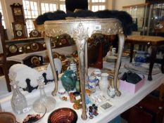 A round silver coloured glass topped table