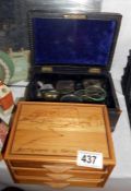 A wooden box with glasses and small set of drawers