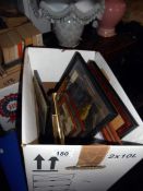 A box of framed prints