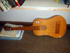 A small acoustic guitar and music books