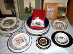 A collection of boxed collectors plates