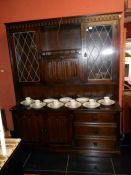 A good quality oak dresser with lead glazed cabinet doors & linen fold doors