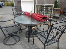A glass topped garden table with parasol and 4 matching garden chairs