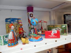 Quantity of tinplate clockwork toys some boxed inc. carousels, duck on bike, clever monkey etc.