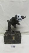 A cold painted bronze panda on black marble base signed Milo