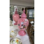 A Victorian hand painted overlaid pink glass lidded vase