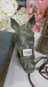 A patinated bronze horse head