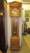 A modern light oak 8 day Westminster chime long case clock