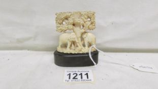 A small ivory carving of elephants under tree
