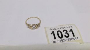 A 14ct yellow gold ring set white sapphire,