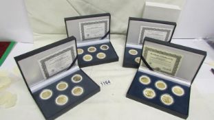 A quantity of gold plated state hood quarter dollars