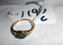 A 9ct gold ring set green stones,