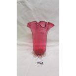A cranberry glass vase