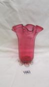 A cranberry glass vase
