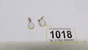 A pair of 9ct gold opal earrings