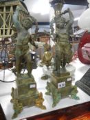 A pair of French spelter 'Garland' cherubs on marble bases