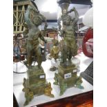 A pair of French spelter 'Garland' cherubs on marble bases