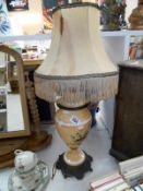A Victorian handpainted table lamp with a metal base and silk shade