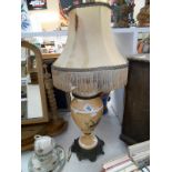 A Victorian handpainted table lamp with a metal base and silk shade