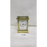 A brass carriage clock marked E.