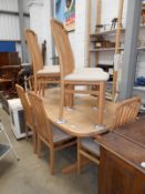 A beech effect extending dining table & 8 chairs