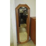 A tall narrow pine frame mirror