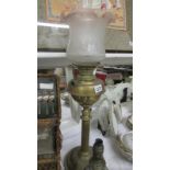 A Victorian brass column Young's oil lamp with later shade