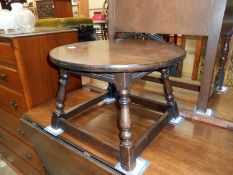 A dark oak round top coffee table