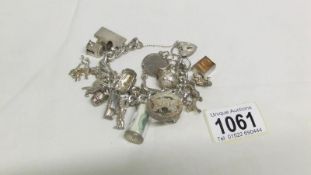 An interesting vintage silver charm bracelet with 25 charms,