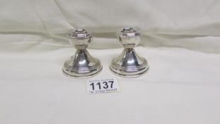 A pair of Birmingham silver candlesticks