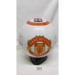 A ceramic football inscribed 'The Manchester United Championship Trophy' on stand