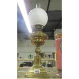 A brass oil lamp complete with shade and chimney