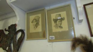 A pair of framed and glazed Tibetan portrait prints signed by the artist G Douglas