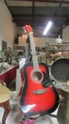 A good quality Falcon FG 100R acoustic guitar with strap and stand