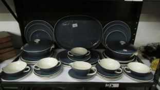 A quantity of Poole pottery dinner ware