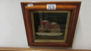 An early 20th century wool work of house in original frame