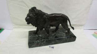 A bronze lion on marble base