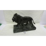 A bronze lion on marble base