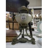 An ornate Victorian oil lamp base with cut glass font