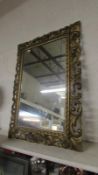 A carved wood gilded wall mirror