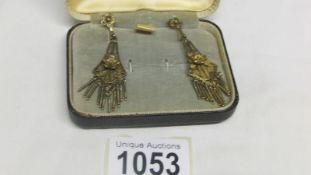 A pair of vintage silver filigree pendant earrings