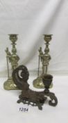 A pair of brass soldier candlesticks and a Victorian candlestick in the form of a mermaid